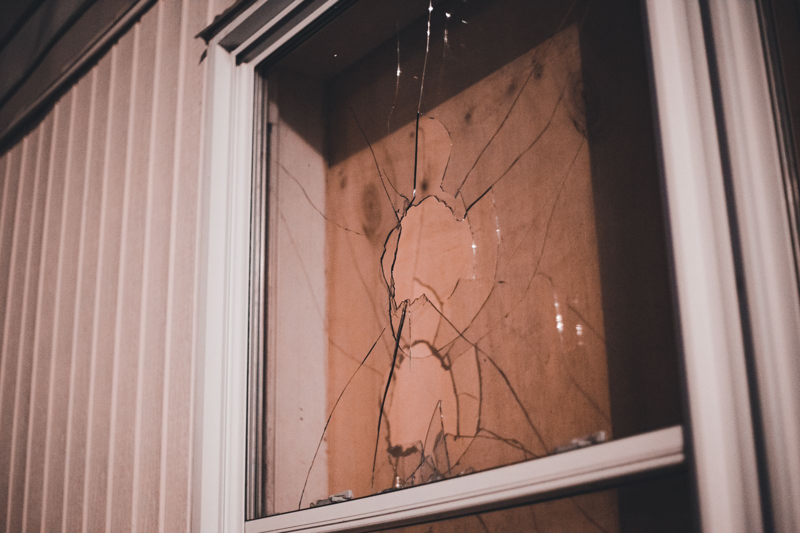 Close-up of a cracked window pane that needs replacing