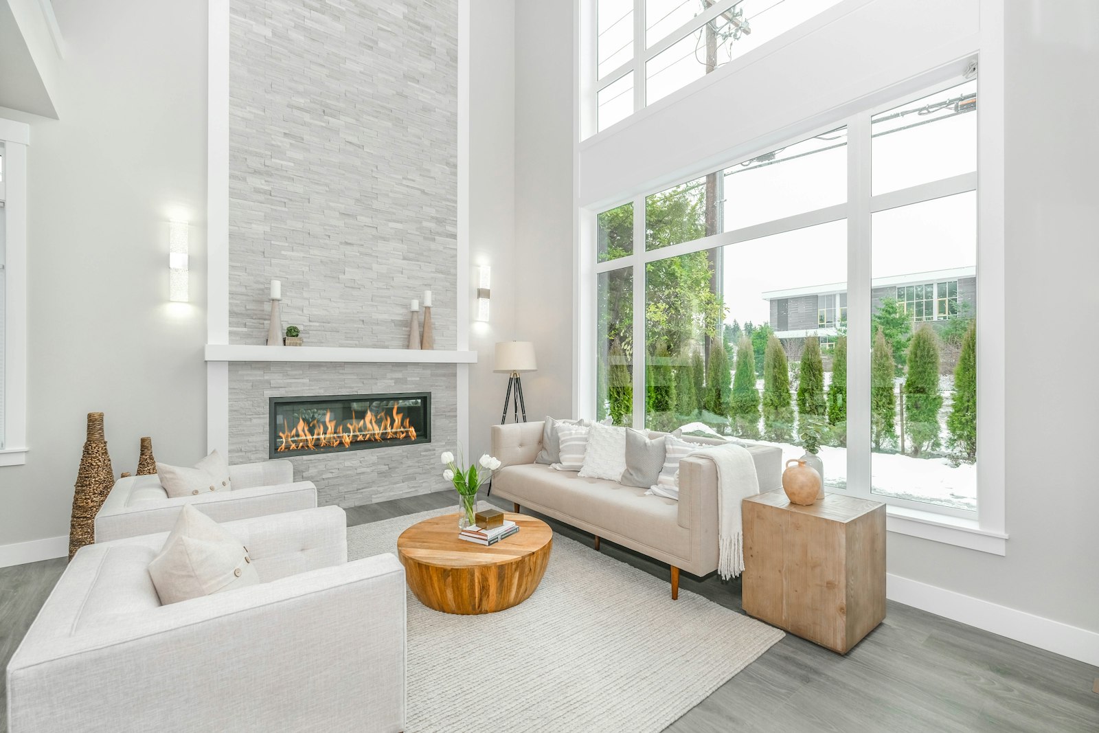Living room with a white sofa beside a large clean window