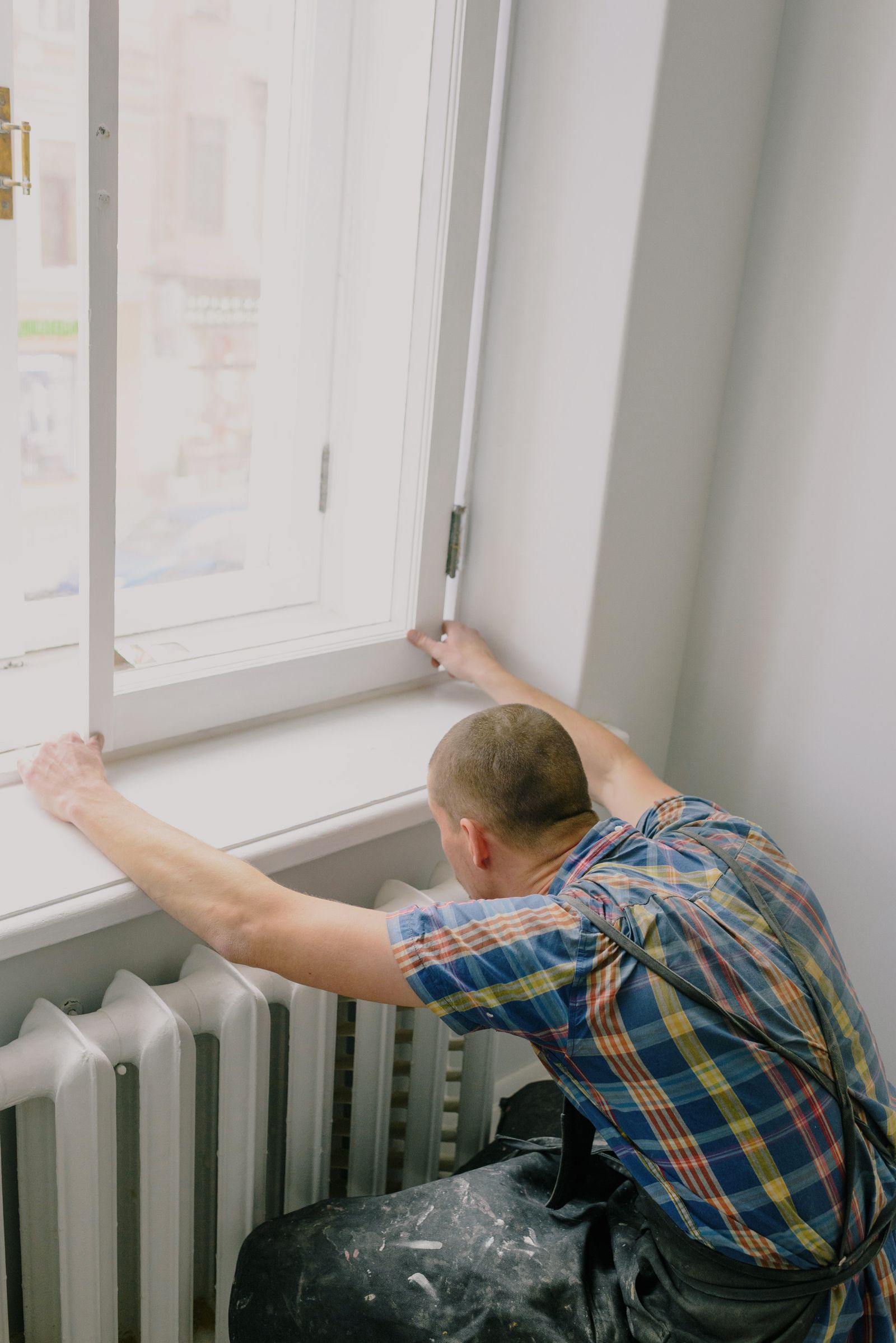 Installer mounting a new window frame in a house