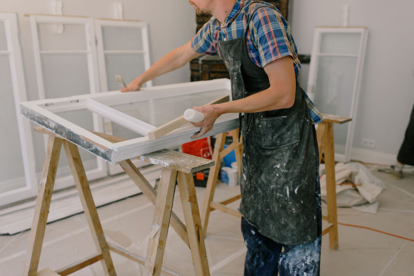 Technician preparing a window frame on a workbench