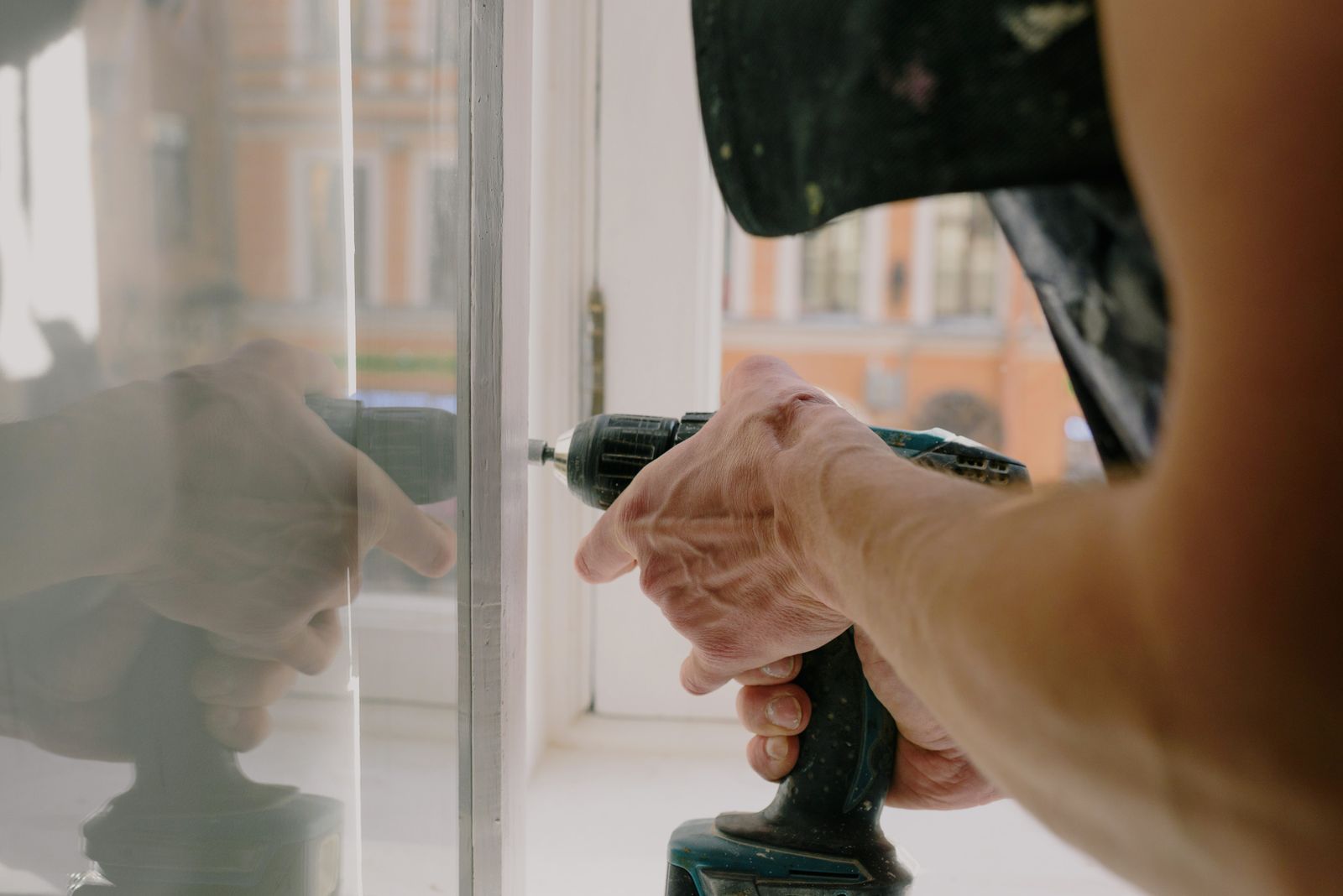 Technician fixing metal hardware on a window